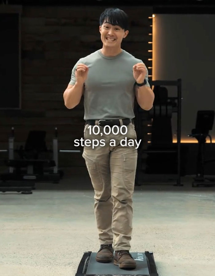 A man demonstrating the Japanese walking trend indoors, highlighting an alternative to 10,000 steps a day for fitness. A man demonstrating the Japanese walking trend indoors, highlighting an alternative to 10,000 steps a day for fitness.