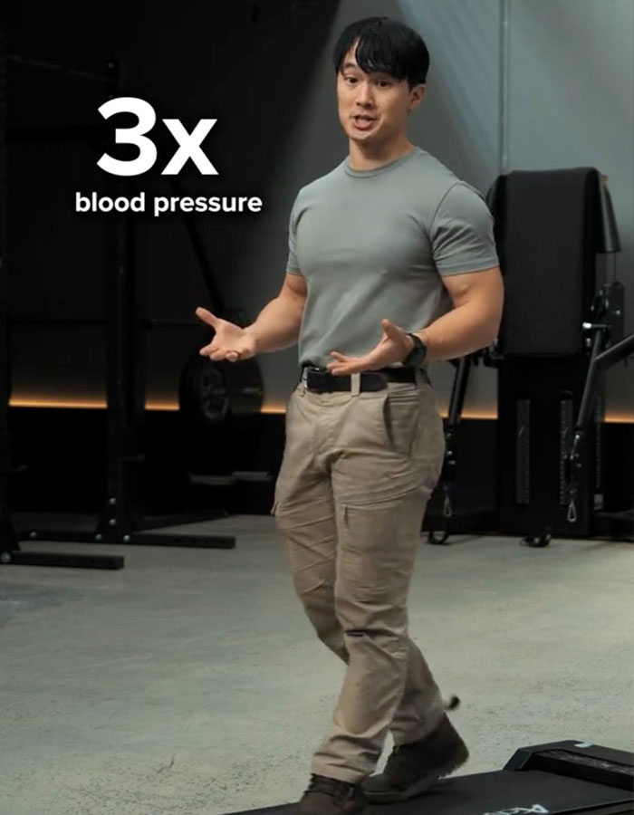 Man demonstrating exercise in gym, explaining Japanese walking trend benefits beyond 10000 steps a day. Man demonstrating exercise in gym, explaining Japanese walking trend benefits beyond 10000 steps a day.