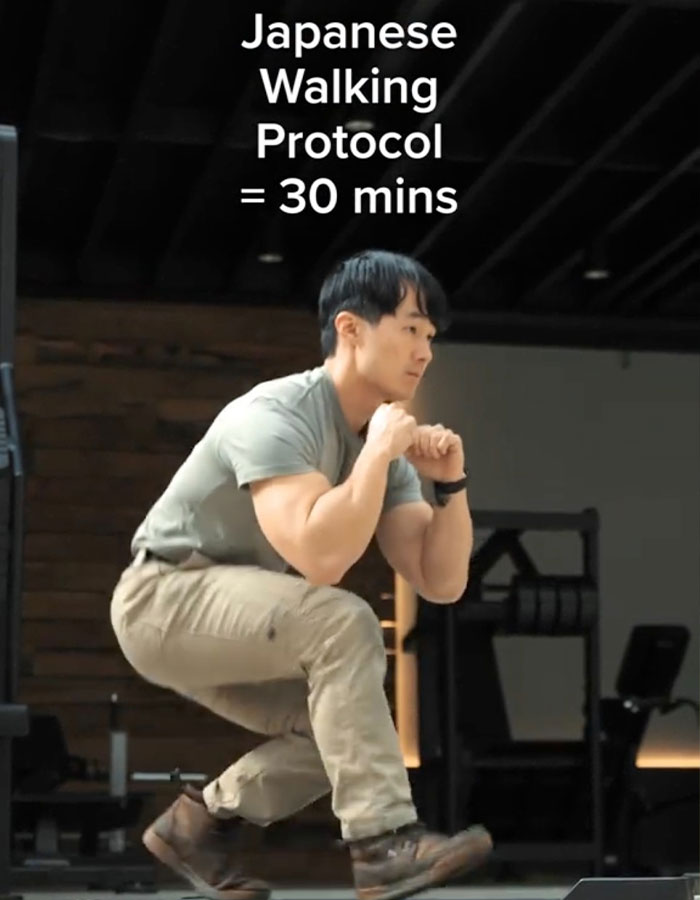 Man demonstrating Japanese walking trend protocol in a gym setting, emphasizing 30 minutes as better than 10000 steps a day. Man demonstrating Japanese walking trend protocol in a gym setting, emphasizing 30 minutes as better than 10000 steps a day.