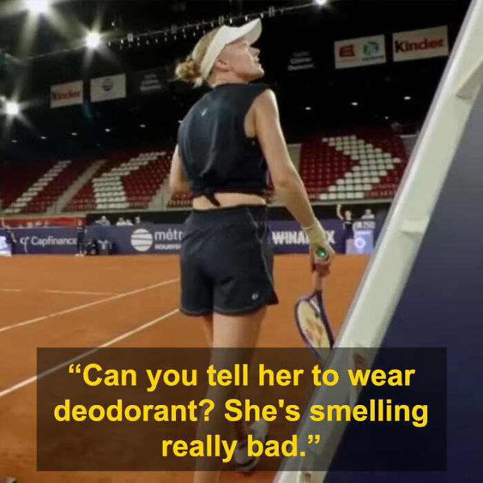 Tennis star reacting to opponent commenting on her odor mid-match during a clay court tennis event at night.
