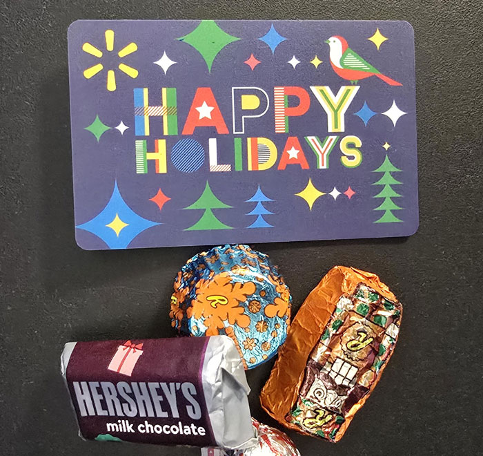 Holiday card with colorful text and small chocolates, illustrating a toxic work environment gift gesture by employees.