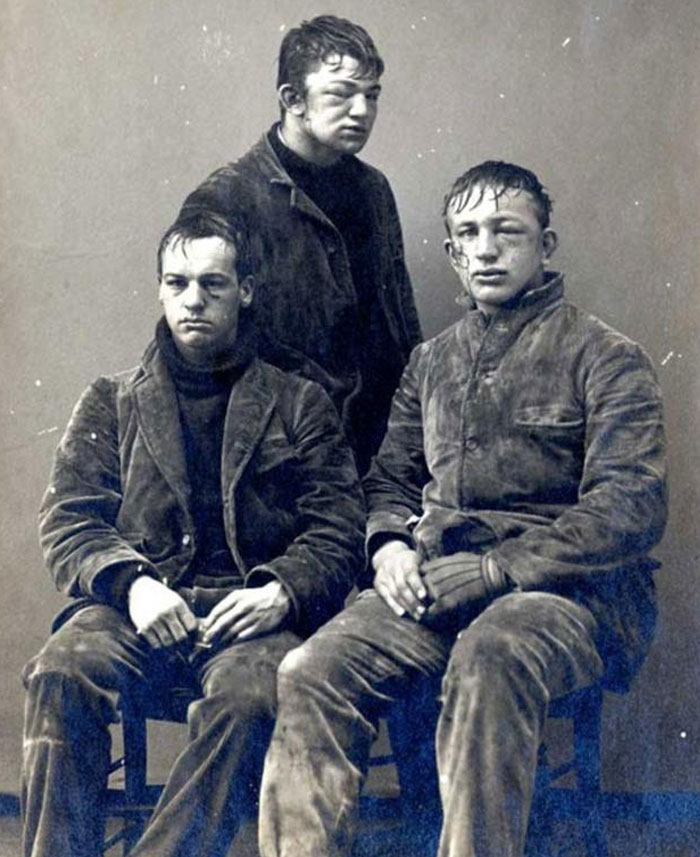 Three men from the past wearing worn clothing with bruised and swollen faces, creating a creepy and unsettling atmosphere.