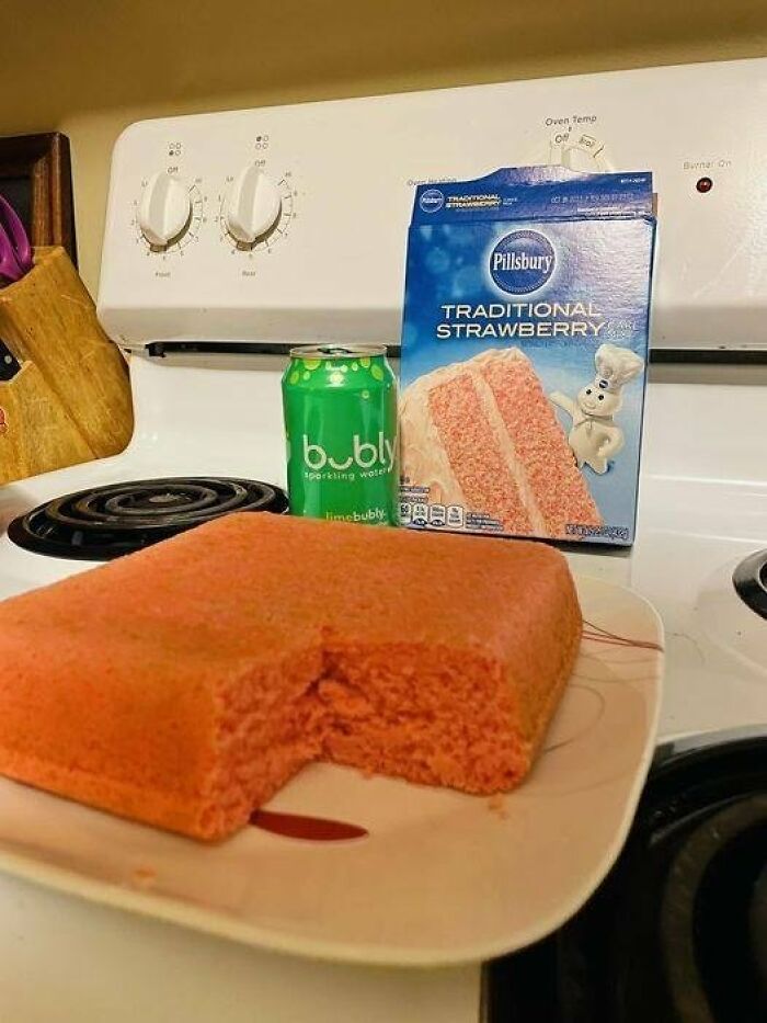 Undecorated homemade cake from a boxed mix with a bite missing, illustrating disgusting food pics that might ruin appetite.