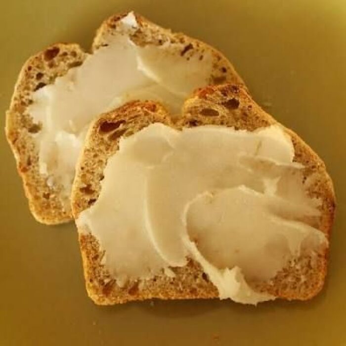 Two slices of bread spread with an unappetizing white substance, featured in disgusting food pics.