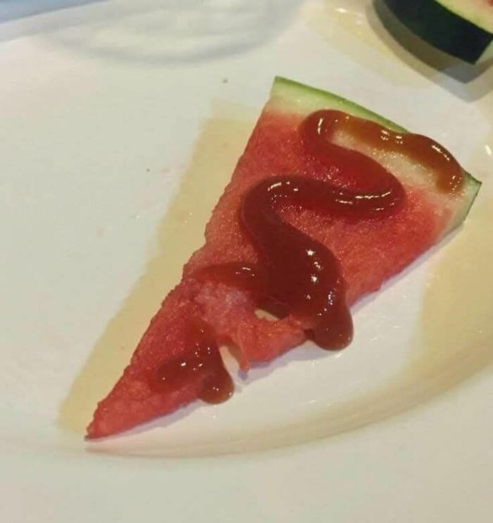 Slice of watermelon with ketchup on a white plate, one of the disgusting food pics to ruin your appetite.