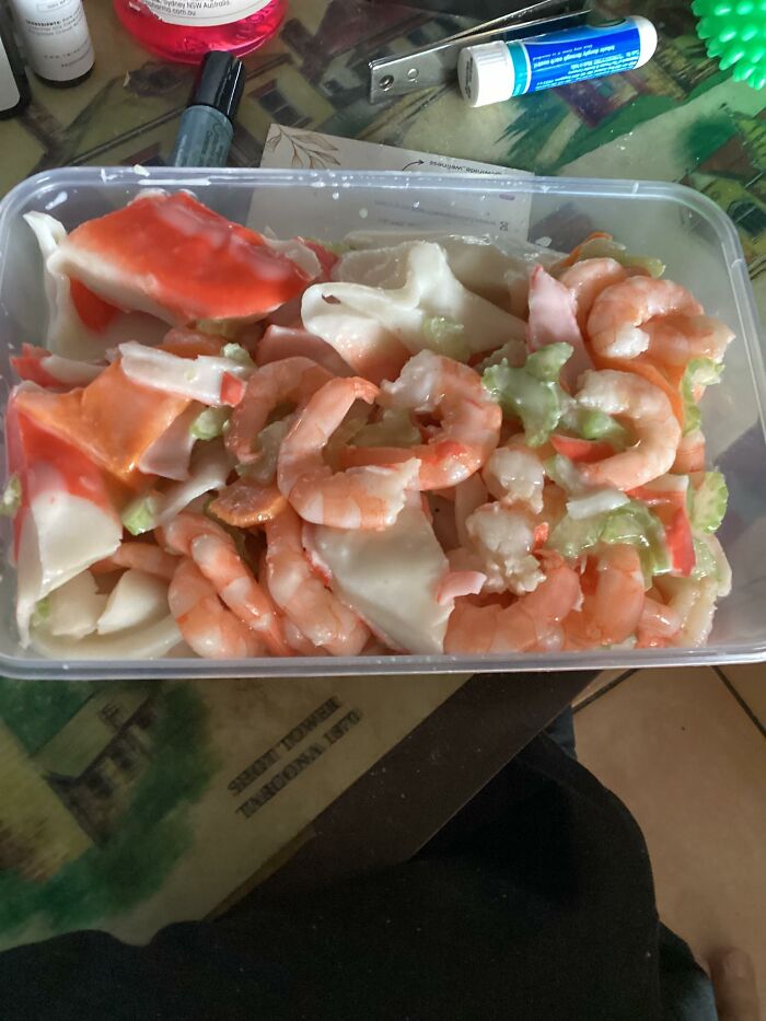 Container of mixed seafood with shrimp and imitation crab, appearing unappetizing in disgusting food pics that might ruin appetite.