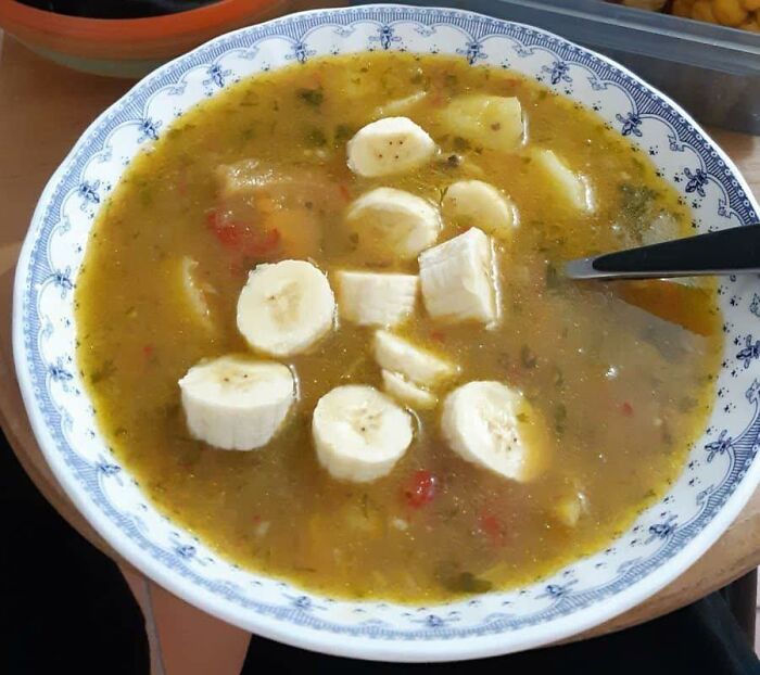 Bowl of unusual food with sliced bananas floating in a thick, savory-looking soup, highlighting disgusting food pics.