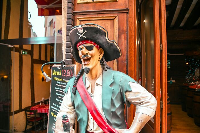 Colorful pirate statue outside a restaurant, illustrating quirky things learned embarrassingly late in life.