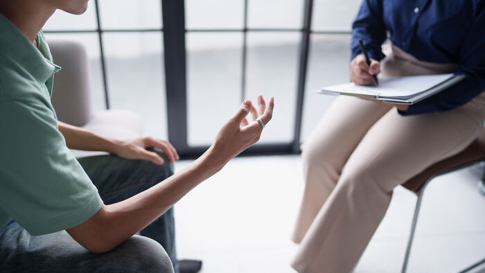 Person sharing thoughts in a counseling session, illustrating things learned embarrassingly late through open conversation.