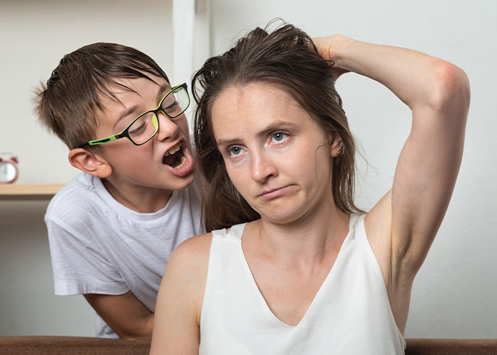 Frustrated woman with child yelling behind her, illustrating modern behaviors people can’t accept due to how they grew up.