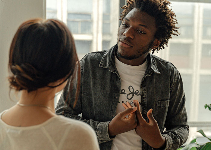 Two people having a serious conversation about modern behaviors they find difficult to accept from their upbringing.