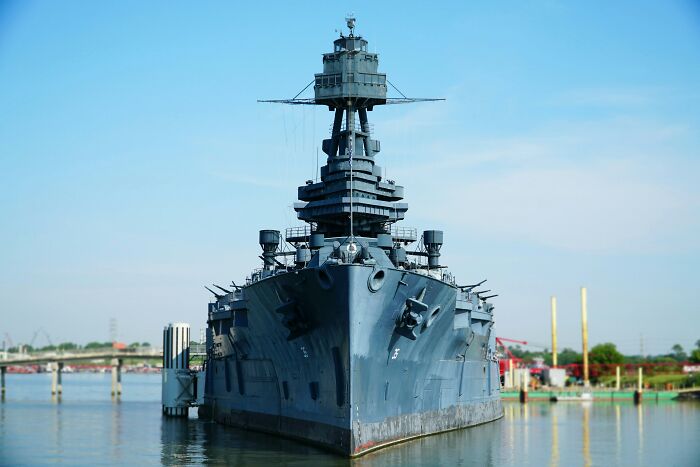 Historic battleship docked at a harbor on a clear day, illustrating fascinating historical facts to amaze you.