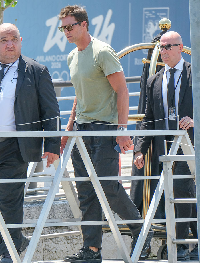 Celebrity walking with security, showing strung-out looks after weekend partying at Jeff Bezos and Lauren S&aacute;nchez wedding.