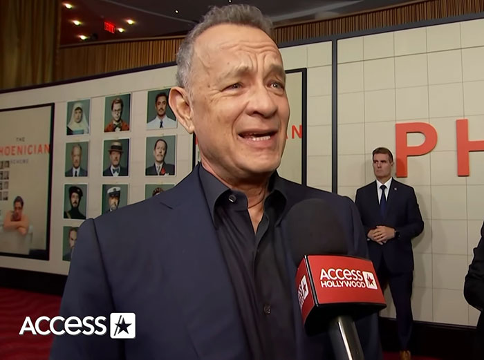 Tom Hanks speaking to Access Hollywood on red carpet amid daughter's childhood confusion and violence claims.