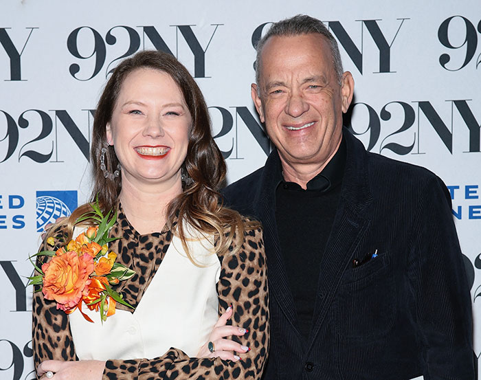 Tom Hanks smiling with daughter at 92NY event, addressing family confusion and childhood violence concerns.