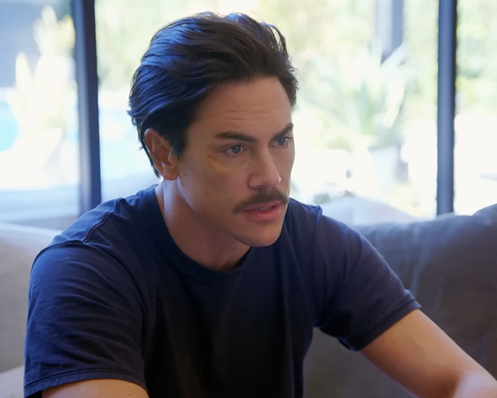 Tom Sandoval sitting indoors, wearing a dark shirt, looking serious during a conversation about America&rsquo;s Got Talent.