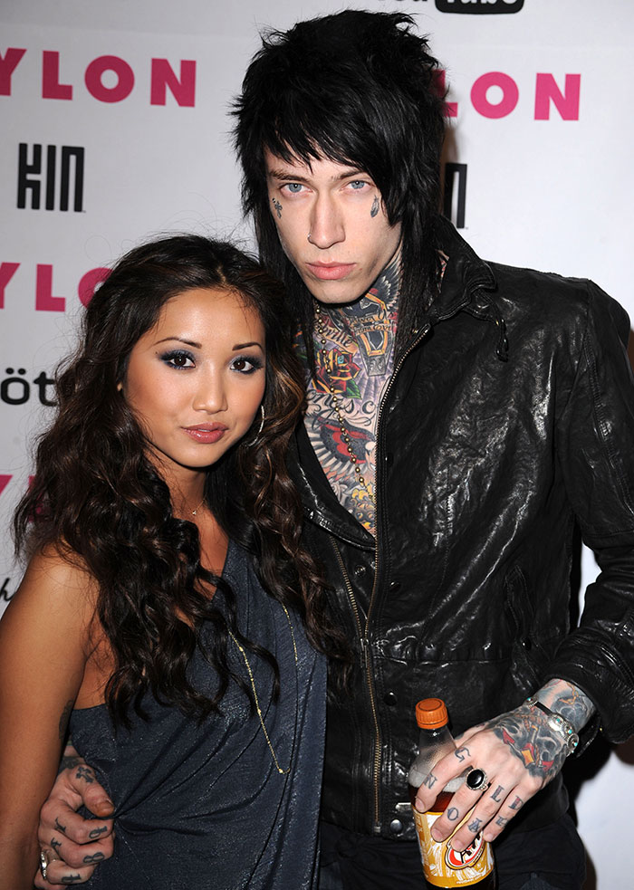 Trace Cyrus and Brenda Song posing together at an event, highlighting accusations of faking pregnancies and cancer.
