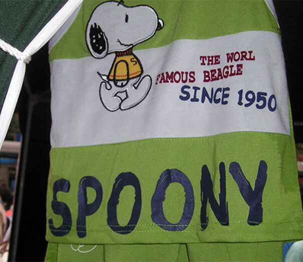 Green and white shirt with funny English text featuring a misspelled phrase and a Snoopy cartoon illustration.