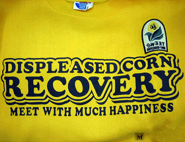 Yellow shirt with funny English phrase displeased corn recovery meet with much happiness, showcasing baffling uses and translations.