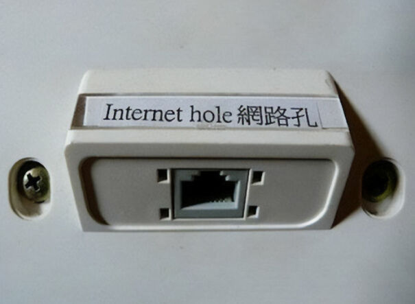 Wall-mounted internet port labeled humorously as internet hole with English and Chinese text, funny usage example.