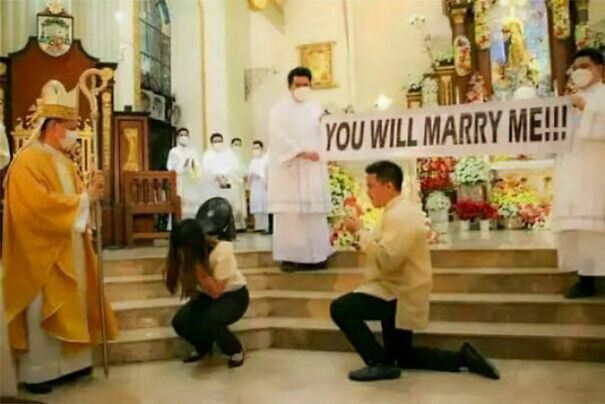 A humorous and baffling use of English in a marriage proposal scene inside a church with people holding a banner.