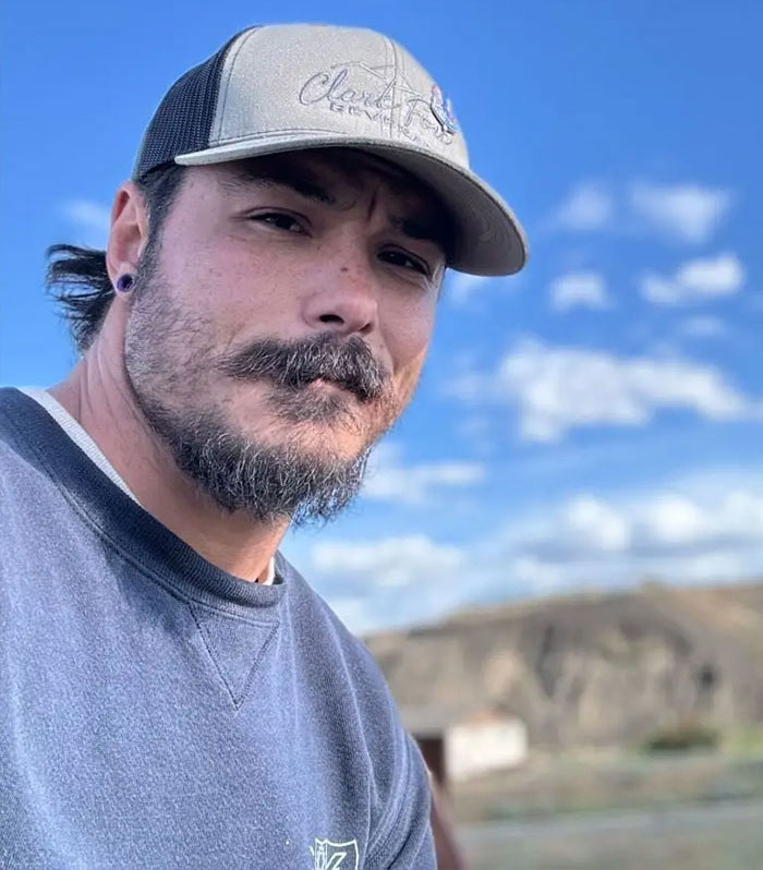 Man with beard and cap outdoors during daytime, related to Travis Decker neighbor recalling weird encounter before tragedy.