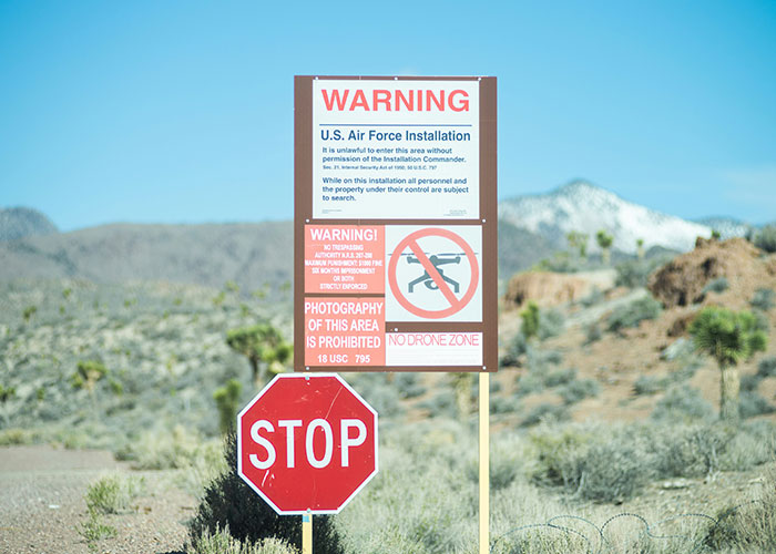 Warning signs at a U.S. Air Force installation in a desert, related to unbelievable experiences that can be proven.