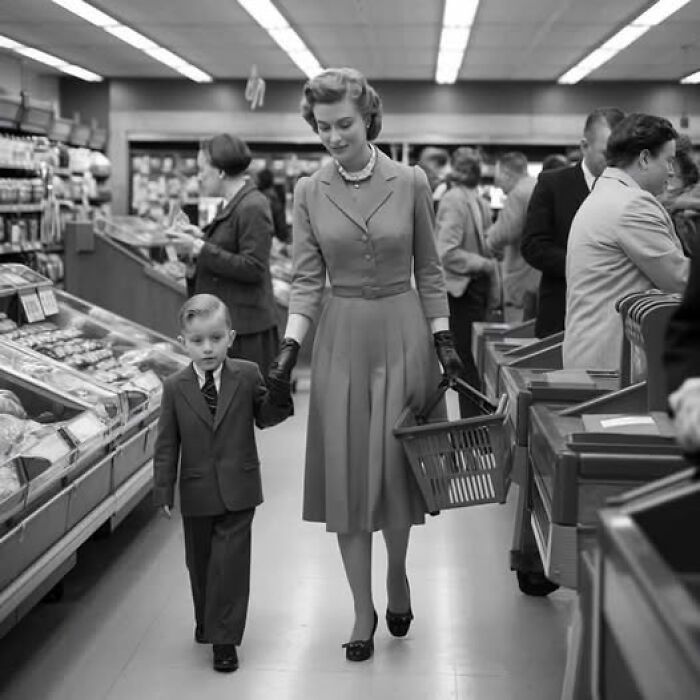 Woman and child shopping in a grocery store, captured in a rare historical photo showcasing mid-20th century fashion and lifestyle.