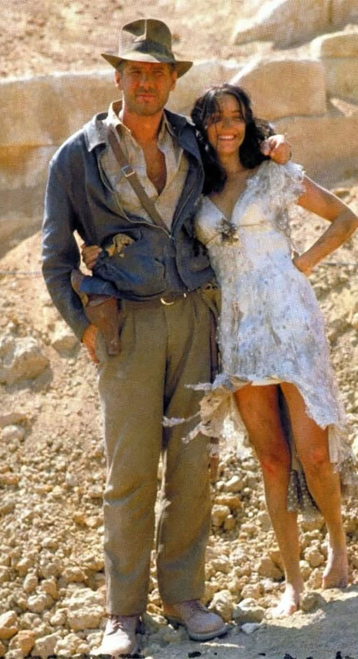 Rare historical photo of a man and woman standing in a desert setting, capturing a moment from the past.