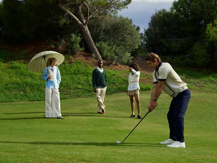Group of people playing golf outdoors, illustrating real world strategies and unethical life hacks in action.