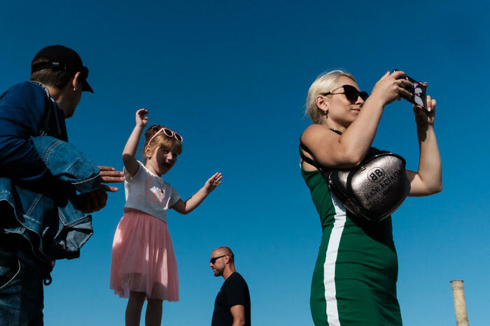 Street photos capturing colorful, candid moments of people enjoying a sunny day with vibrant blue sky background.