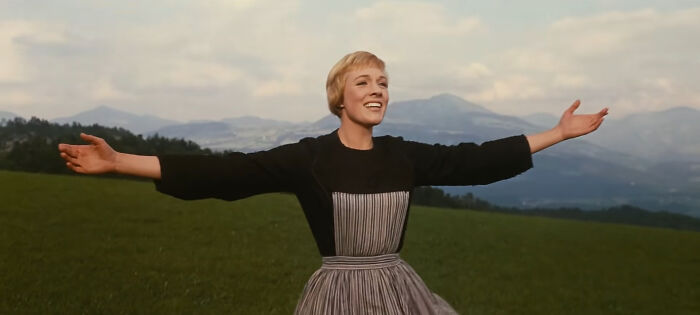 Woman in a scenic European countryside, representing European netizens correcting commonly mistaken facts about their countries.