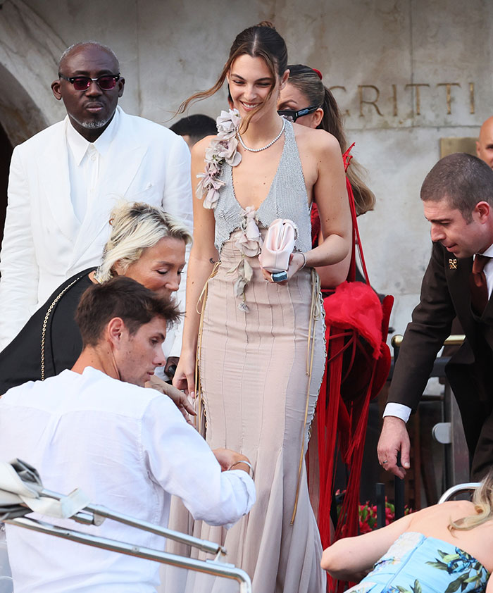 Leonardo DiCaprio's girlfriend smiling in a gown with wardrobe malfunction at Jeff Bezos and Lauren Sánchez's wedding. Leonardo DiCaprio's girlfriend smiling in a gown with wardrobe malfunction at Jeff Bezos and Lauren Sánchez's wedding.