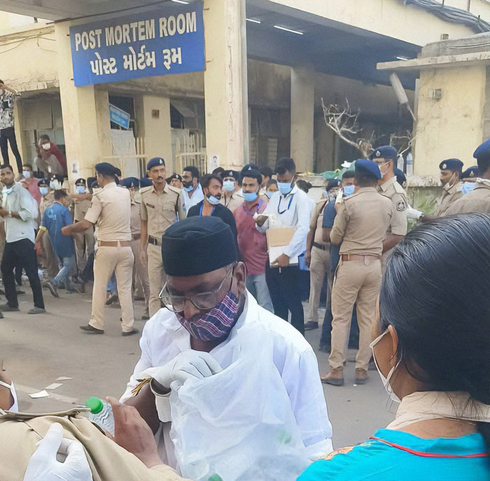 Medical staff and police outside Post Mortem Room as young medical students share gut-wrenching stories after Air India crash