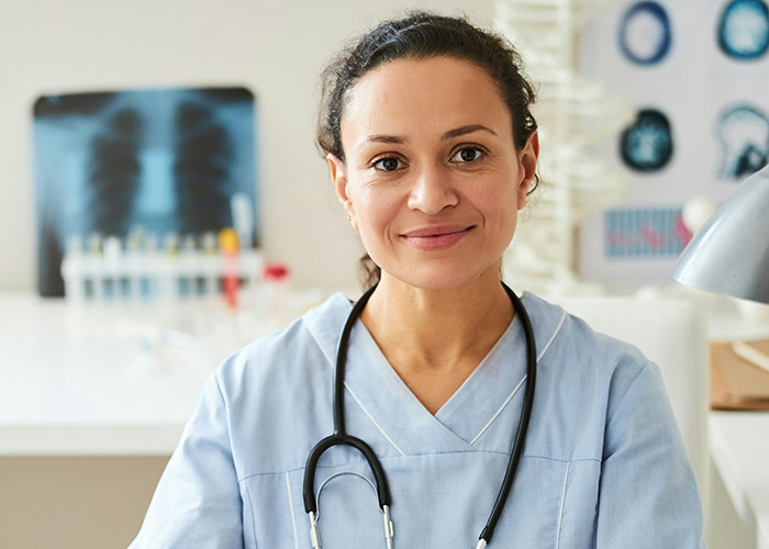 Young female medical professional in a clinic setting, symbolizing women using microfeminism to counter toxic masculinity.