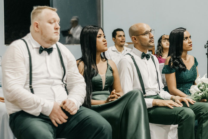 Wedding guests shock and confusion visible as they listen during couple's unexpected elopement reveal at formal event. Wedding guests shock and confusion visible as they listen during couple's unexpected elopement reveal at formal event.