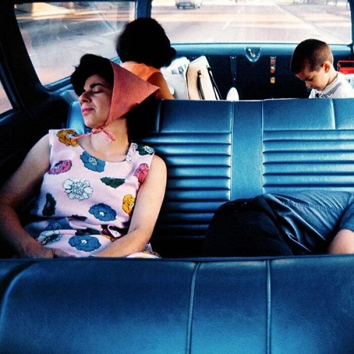 Four people inside a car, including a woman in a floral dress and scarf, illustrating weird things about history.