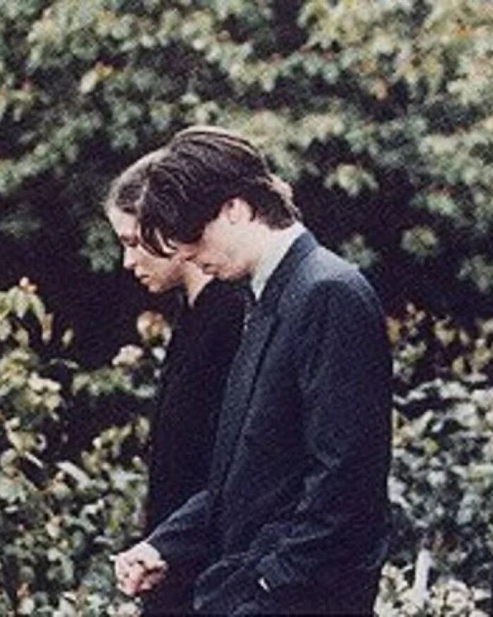 Two people dressed in vintage-style clothing walking outdoors, evoking a scene from weird history moments.