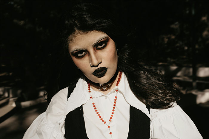 Woman with dark makeup and gothic style expressing displeasure reflecting icks men gave women in dating experiences.