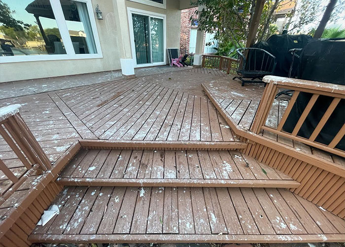 Wooden deck covered with bird poop stains highlighting the public health risk of bird droppings on outdoor surfaces