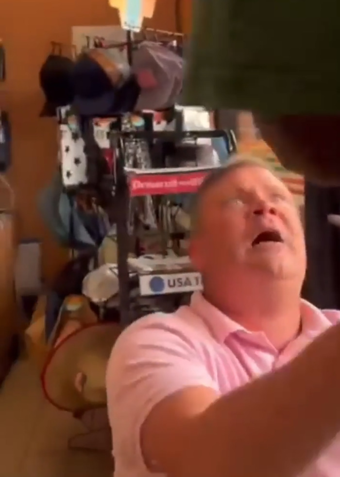 Middle-aged man in a store brawl shouting during viral incident involving a racial slur and a black shopper.