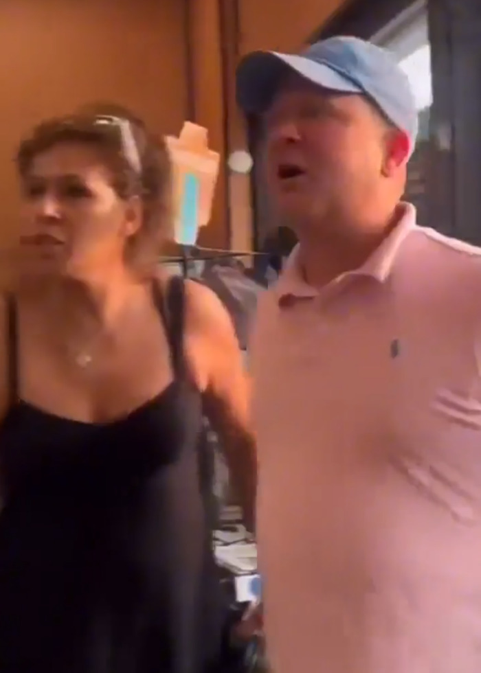 Two people in a heated moment during a viral store brawl involving a man who called a black shopper a slur.