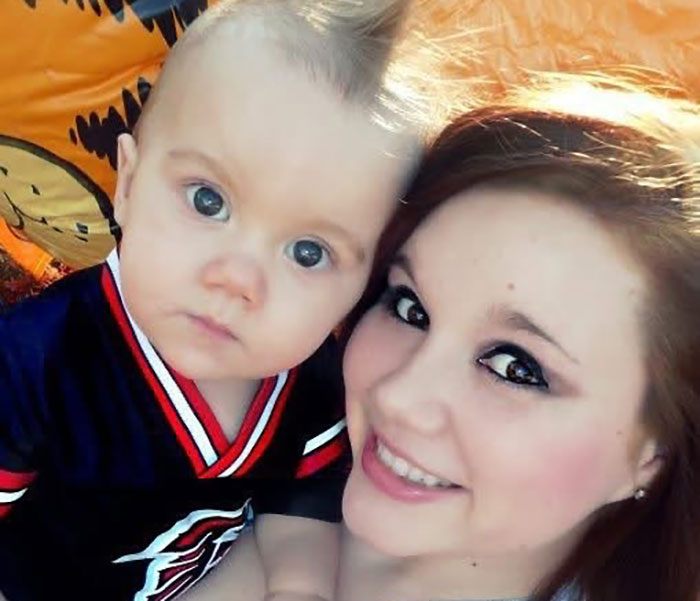 Whitney Purvis from 16 and Pregnant smiling with a young child, both looking at the camera in a close-up photo.