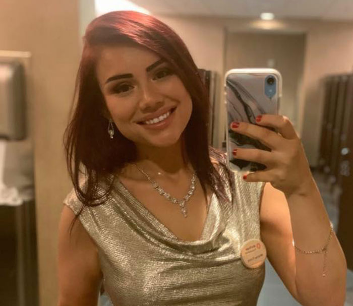 Whitney Purvis, 16 and Pregnant star, taking a selfie smiling in a silver dress with necklace and earrings indoors.