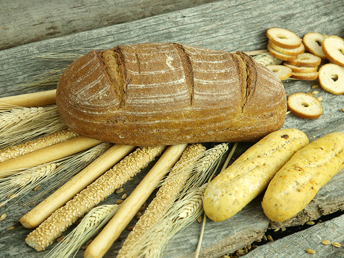 Loaf of bread and assorted breadsticks on wooden surface showing remove your stuff or will final destination concept.