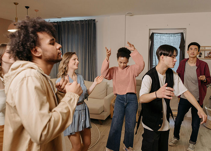 A diverse group of people enjoying wholesome interactions with strangers in a cozy home setting.