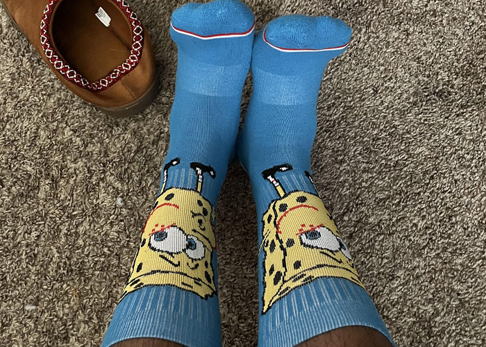 Person wearing blue SpongeBob socks on carpet, capturing a wholesome interaction with strangers moment.