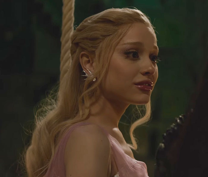 Ariana Grande with long blonde hair and ghoulish makeup, highlighting entirely visible ribcage in Wicked trailer scene.