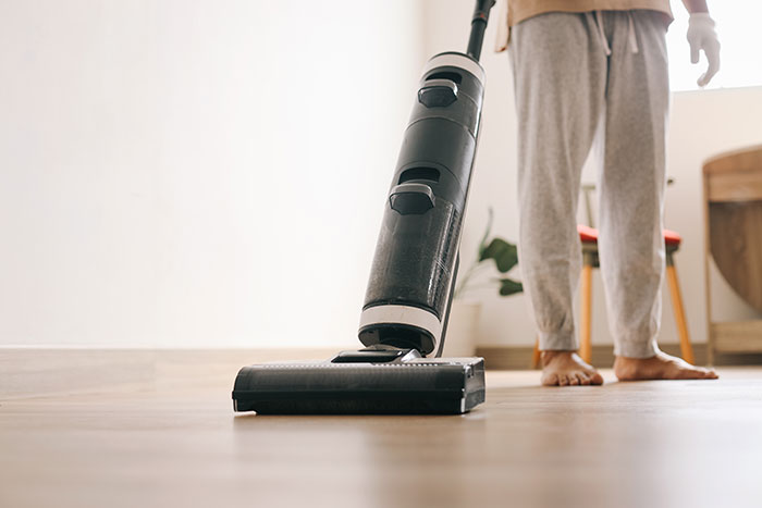 Person using a vacuum cleaner illustrating products with design flaws that cause frustration and rage every time.