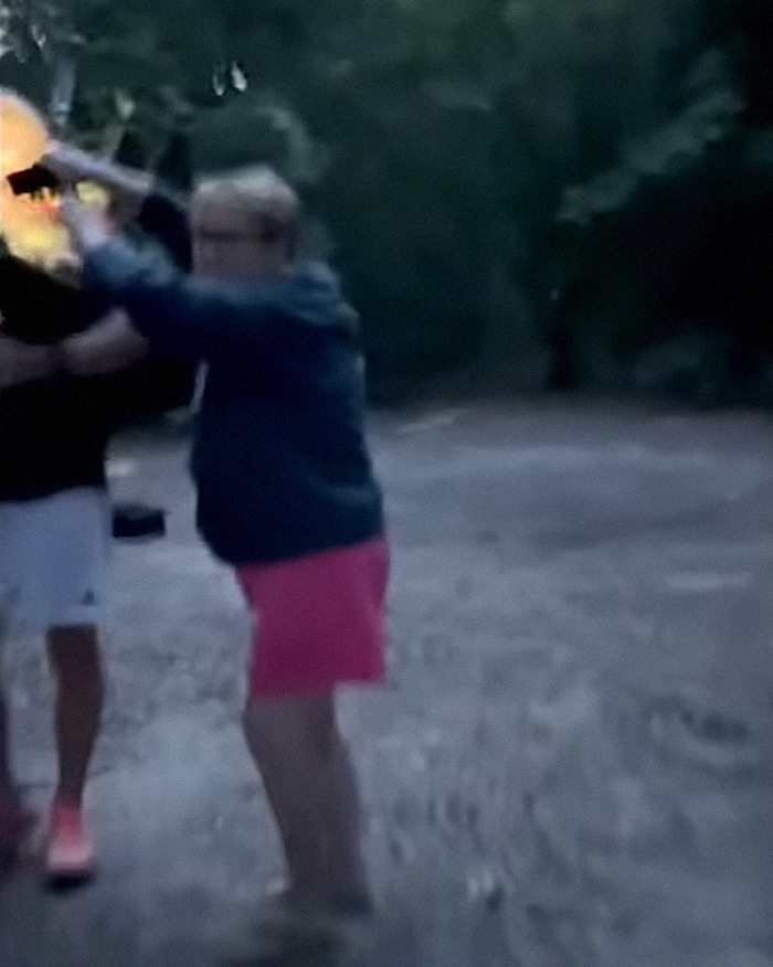 Woman aggressively confronting man in park during Bagpipe Karen instant karma incident at dusk.